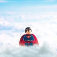 LEGO Superman floating above a sea of clouds.
