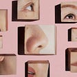 Framed photos of closeups of different people’s facial features at different angles—noses, eyes, mouths—on a pink wall.