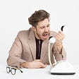 A man yelling into a telephone.
