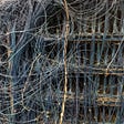 The complex, hand-wired backplane of an electromechanical supercomputer at the Computer History Museum boneyard; it is an impossible tangle of wires joining various subassemblies.