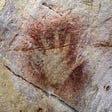 A negative hand, one of the oldest types of imagery in the world, found in El Castillo. Negative hands were often made using a spit-painting technique in which someone would place their hand on the cave wall and “spit” paint over and around the hand, leaving an outline.