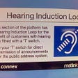 A sign in a train station advising travellers that the public announcement system broadcasts with a hearing induction loop, to allow travellers with a hearing aid to tune into announcements directly with their hearing aid’s receiver. Courtesy Wikimedia commons user avlxyz.