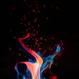 A black background with red, blue, orange, and pink flames dancing