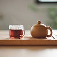 Photo of a tea pot and a tea cup.