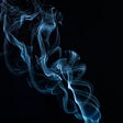 Whisps of smoke against a black background