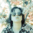 woman in sunglasses in the blossom tree taken using vintage lens-COPYRIGHT SARAH-JANE WHITE 2020