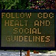 A digital traffic sign, with typo, alerts people to find and refer to CDC guidelines during the COVID-19 pandemic.