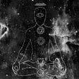 A human figure meditates over the cosmos. The chakras are depicted.