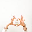 Laura Chouette hands holding chanel perfume bottle