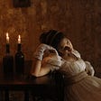 Woman in period costume leaning against a table with candles in bottles