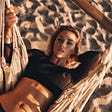 just-relaxing-top-view-attractive-young-woman-looking-camera-while-lying-down-hammock-beach — Un Swede