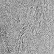 black and white photo of barely perceptible waves in sand with tiny breathing holes of underground life