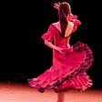 Woman dancing flamenco with a red dress