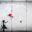 Stencil graffiti of girl reaching for a lost red balloon