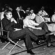 Photograph of the 1946 colloquium on the Super at Los Alamos. Front row left to right: Norris Bradbury, John Manley, Enrico Fermi and J.M.B. Kellogg. Second row left to right: Colonel Oliver G. Haywood, unknown, Robert Oppenheimer, Richard Feynman, Phil B. Porter. Third row left to right: : Edward Teller, Gregory Breit, Arthur Hemmendinger, Arthur Schelberg.