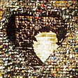 A picture of a large metal heart against a red brick wall. The heart is covered in colourful locks with a partial heart-shaped shadow in the background.