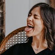 Woman laughing and sticking her tongue out.