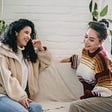 Happy women talking on a couch and being perfect listeners