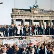 Source: https://commons.wikimedia.org/wiki/File:West_and_East_Germans_at_the_Brandenburg_Gate_in_1989.jpg
