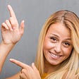 face-closeup-portrait-natural-young-blonde-woman-pointing-side — Un Swede