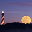 A black and white striped lighthouse at night, against a purple sky with a big yellow moon rising up next to it and its shining beam)