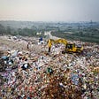 Picture of a bulldozer moving garbage in a landfill