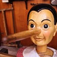 A dummy version of Pinnochio with nose grown large.
