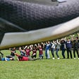 Our 13 members in iGEM NTHU 2020 lifting a huge shoe.