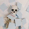 A skeleton surrounded by blue post-it notes. One of the notes says “Burnout”.