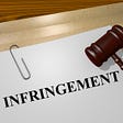 Picture of a folder and document titled “Infringement”