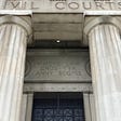 Civil Courts building with doric columns and engraving above door: “Where Law Ends Tyranny Begins.”