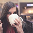 A women drinking coffee.
