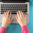 Woman’s hands typing at computer
