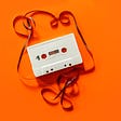 A white cassette on orange background