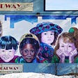 A mural that shows seven kids of different races