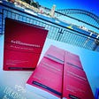 Effinmoments books being signed with the Sydney Harbour Bridge and Opera House as a backdrop