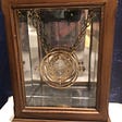 A time turner necklace from Harry Potter in a small glass display box