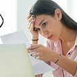 An individual in front of a laptop looking at a piece of paper in disbelief with a speech bubble saying “How could I let this happen?”