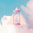 Digital illustration of an hour glass over a pink and blue cloudy sky.