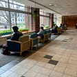 Students studying in a row in HUB Robeson center chairs.