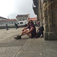 Michelle sitting on the ground after arriving in Santiago de Compostela