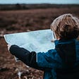 A child traveling looking into a map