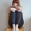 young teenager with red hair, sitting in chair, hugging her knees and just peeking out with her eyes Lisa Gerard Braun Medium