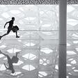 Person with briefcase running over a glass floor