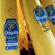 A close up of Chiquita bananas with the stickers showing