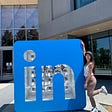 Me posing with the LinkedIn logo sign at LinkedIn HQ.