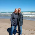 The author (left) and her identical twin on the shores of Lake Michigan at the Indiana dunes.