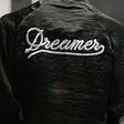 A shirt from backside, which reads “Dreamer”.