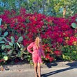 Betsy standing in front of flowers in Santa Barbara