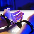 two hands handcuffed, as they may be to enrol in kink play